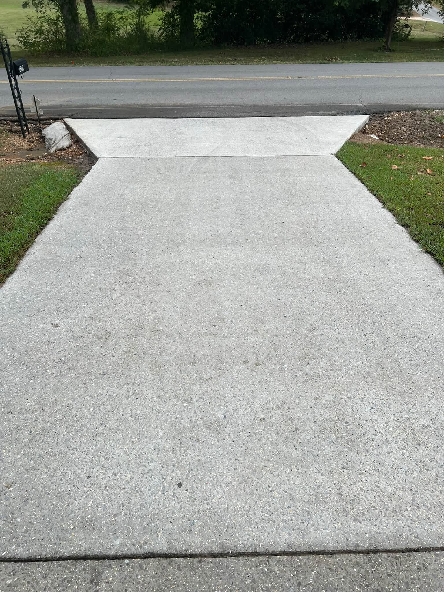 Driveway after professional concrete cleaning by Steadfast Exterior Services